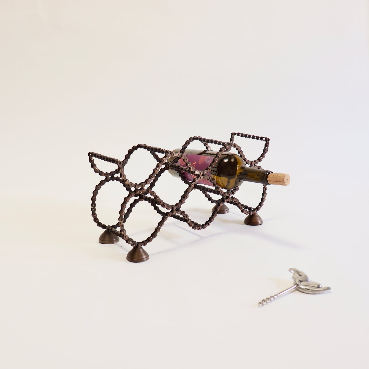 Handmade six bottle wine rack crafted from reclaimed bicycle chain