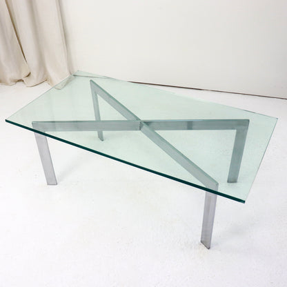 Barcelona-style coffee table with glass top and steel legs