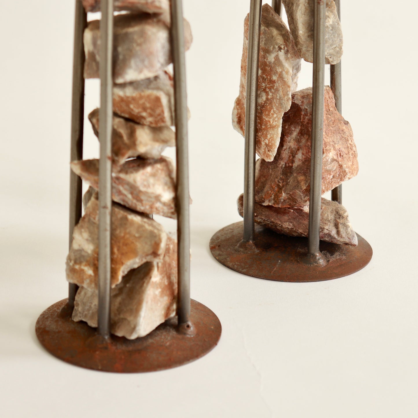 Close up of raw stone in steel cage candle holder
