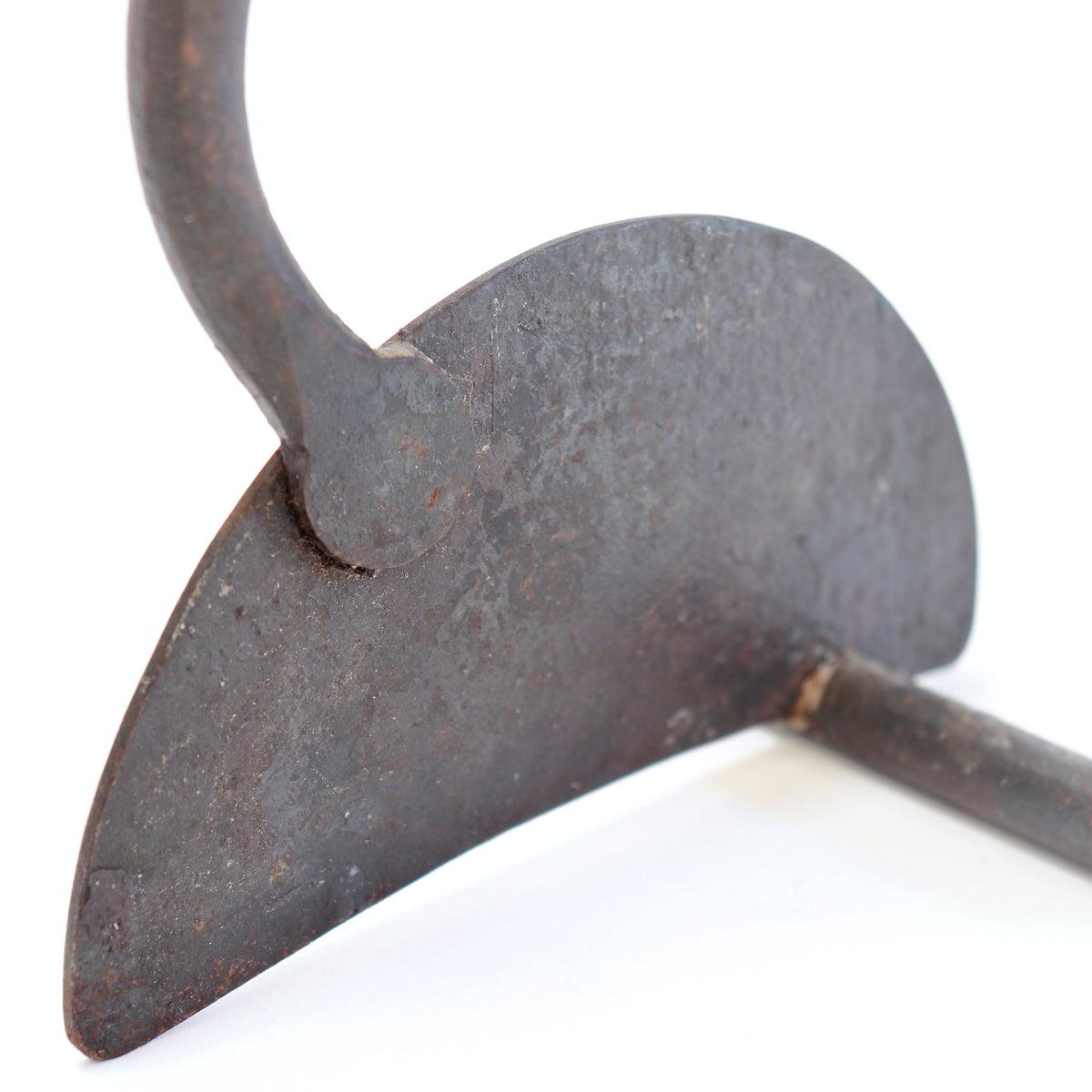 Semicircular iron base with a dark mottled patina, impressed mark and supporting crossbar.
