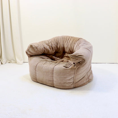 “Front three-quarter view of Michel Ducaroy Brigantin armchair for Ligne Roset in taupe corduroy.”
