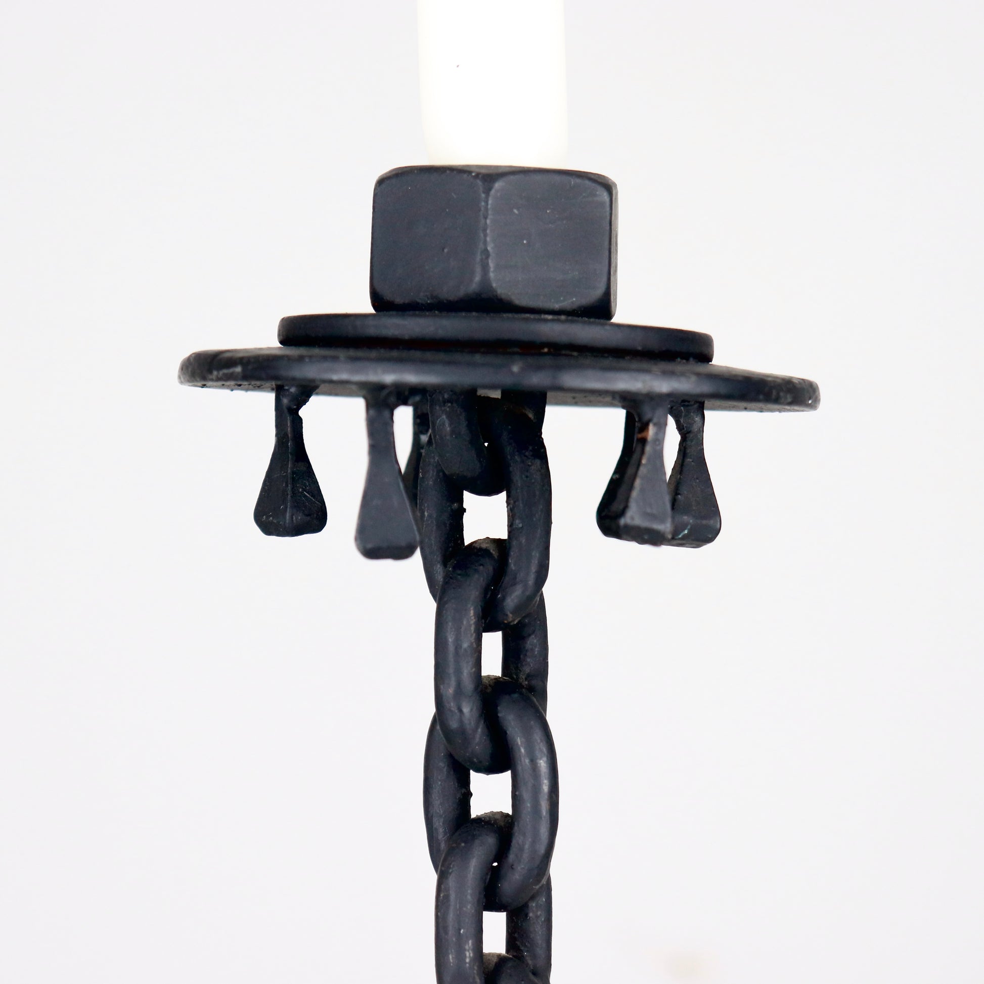 Close-up of forged drip tray with hanging iron details