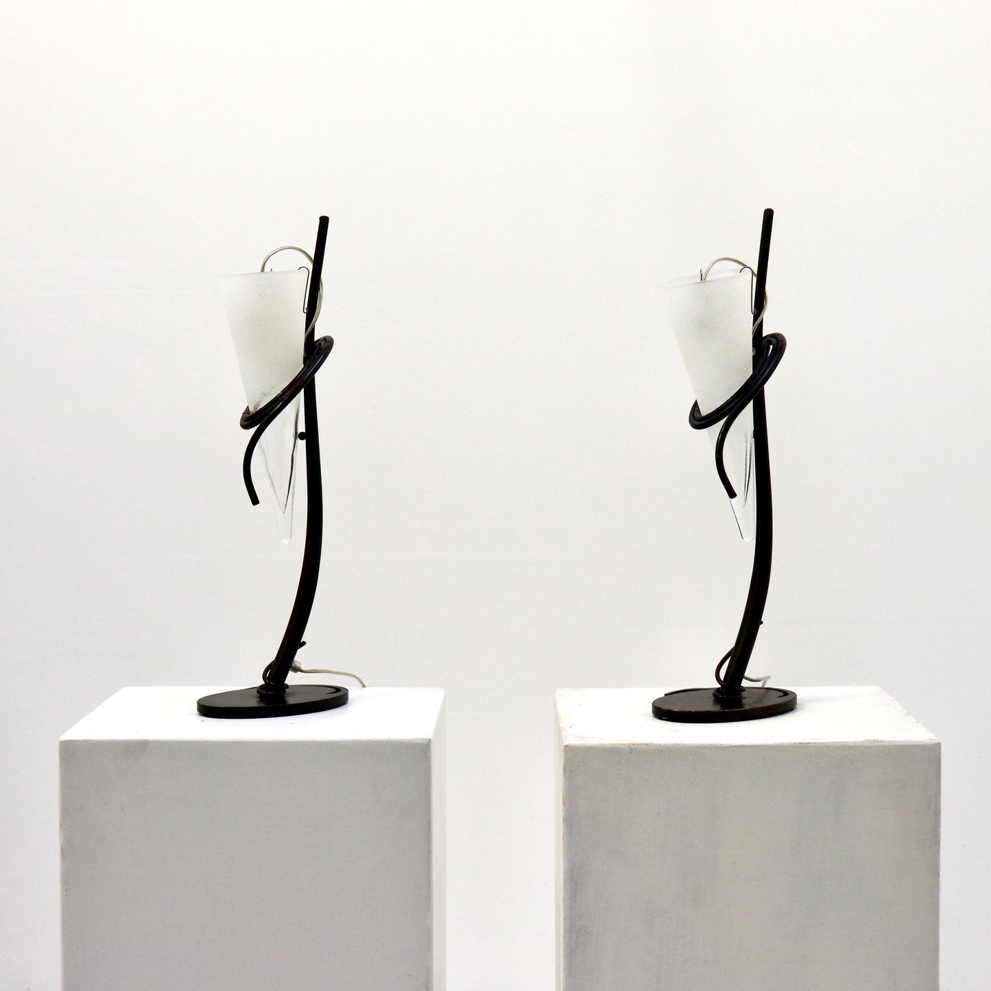 Pair of Italian hand-forged iron table lamps with conical frosted glass shades, front view.