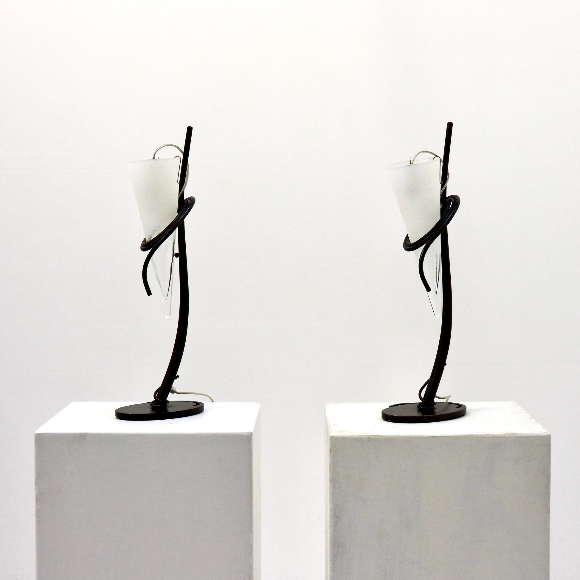 Pair of Italian hand-forged iron table lamps with conical frosted glass shades, front view.