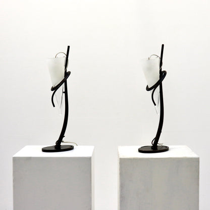 Pair of Italian hand-forged iron table lamps with conical frosted glass shades, front view.