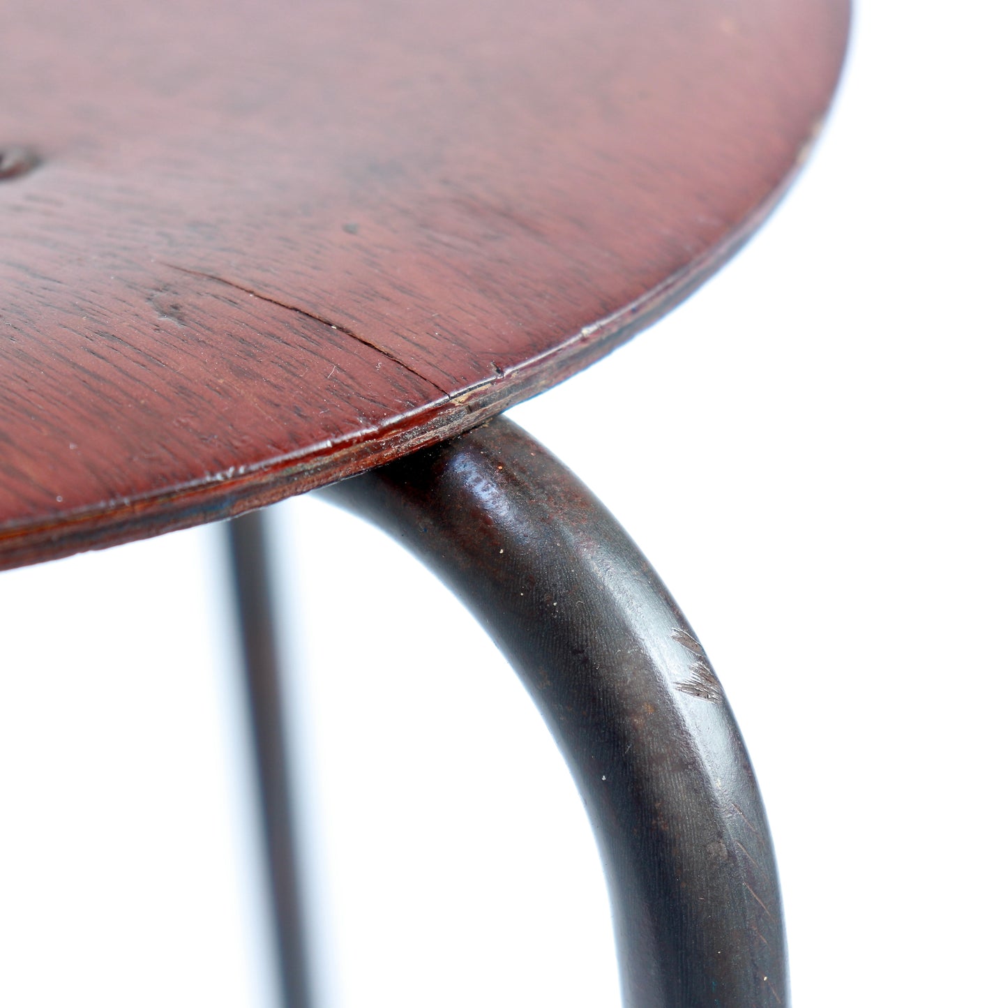 Detail of curved steel leg and timber seat edge