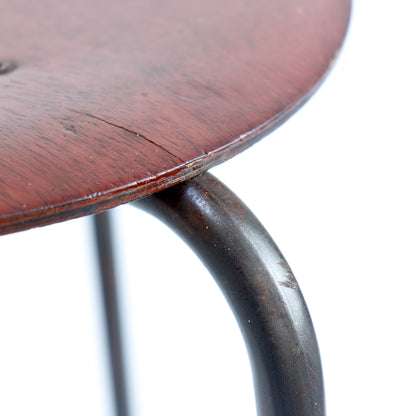 Detail of curved steel leg and timber seat edge