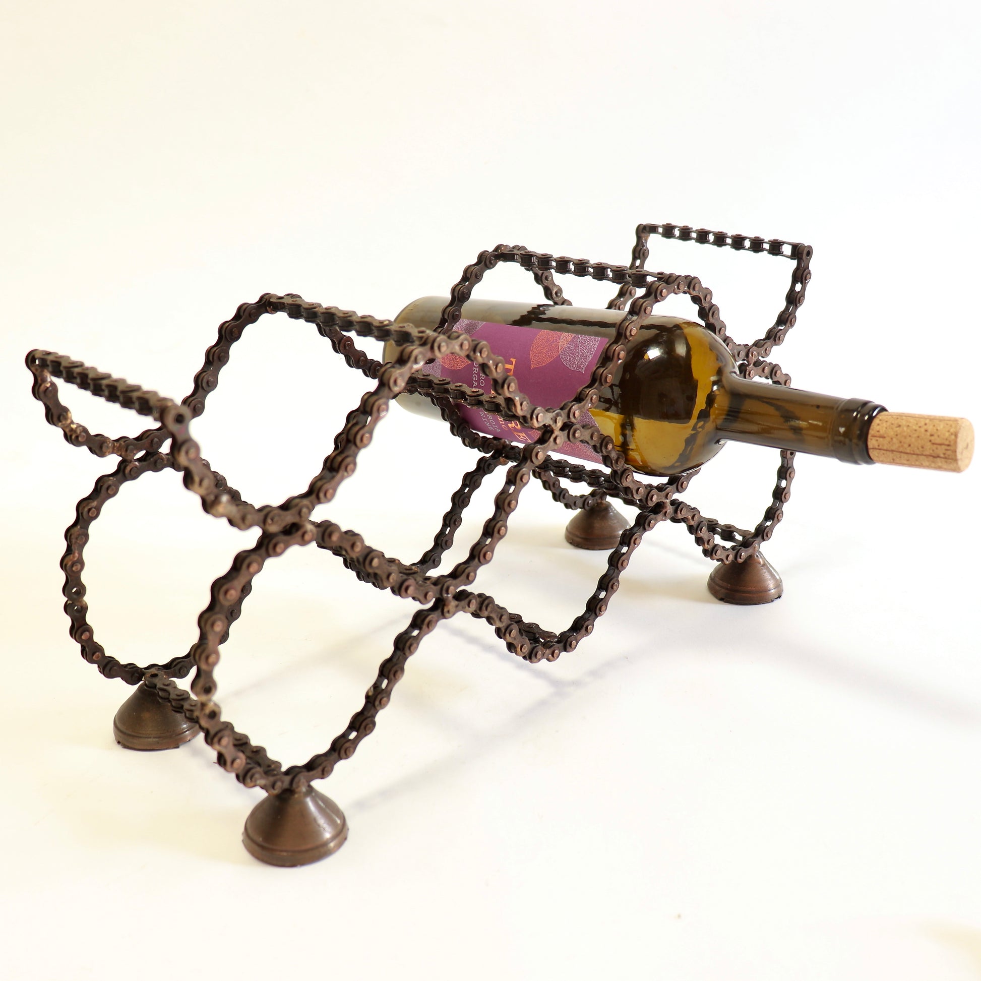 Industrial folk art wine bottle holder with geometric design