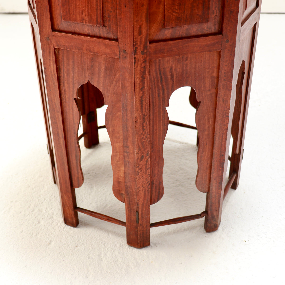 Detail of the arched base panels, wooden pegs and slender lower stretchers.