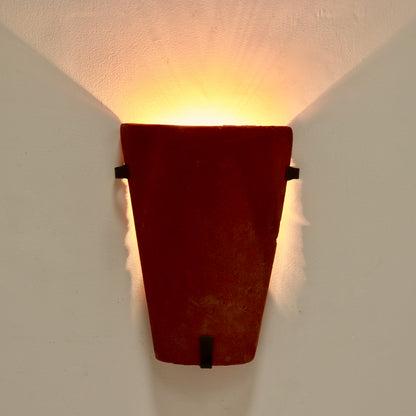 Warm uplight effect from terracotta wall sconce