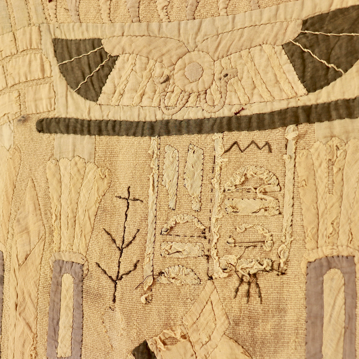 Close-up of the hand stitching and worn textile surface