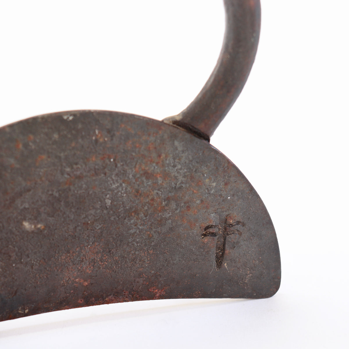 Close-up of the unidentified impressed mark on the patinated iron base.
