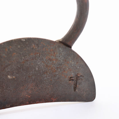 Close-up of the unidentified impressed mark on the patinated iron base.