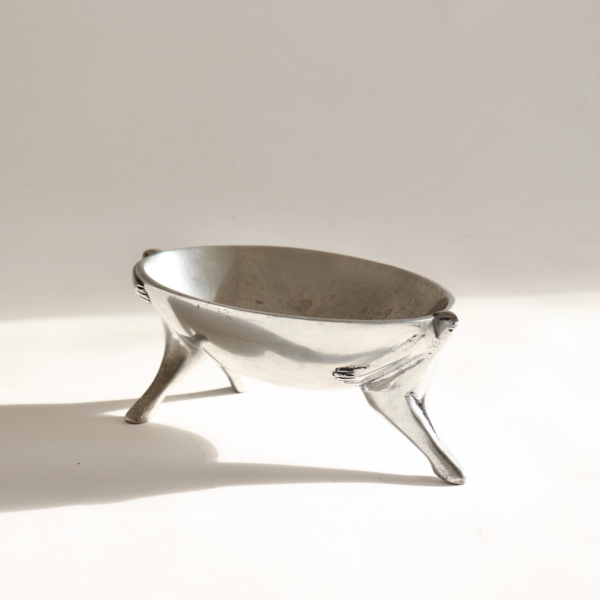 Figural serving dish with stylised human forms