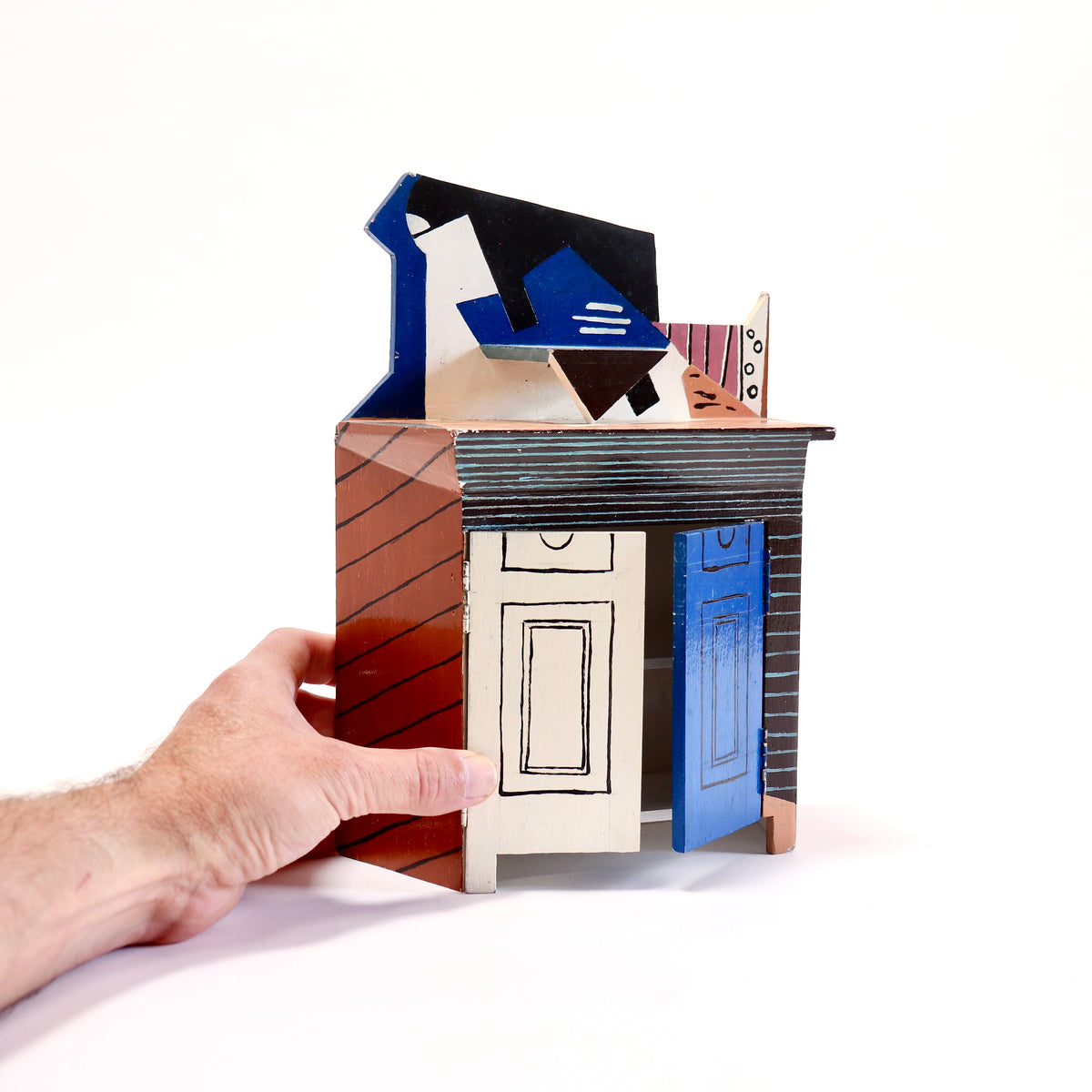 Small hand-painted plywood cupboard with sculptural Cubist top