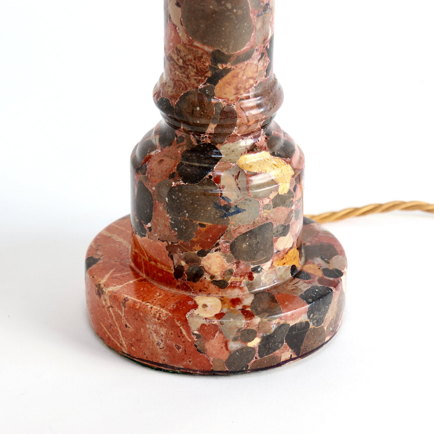 Close-up of breccia marble lamp base with natural inclusions