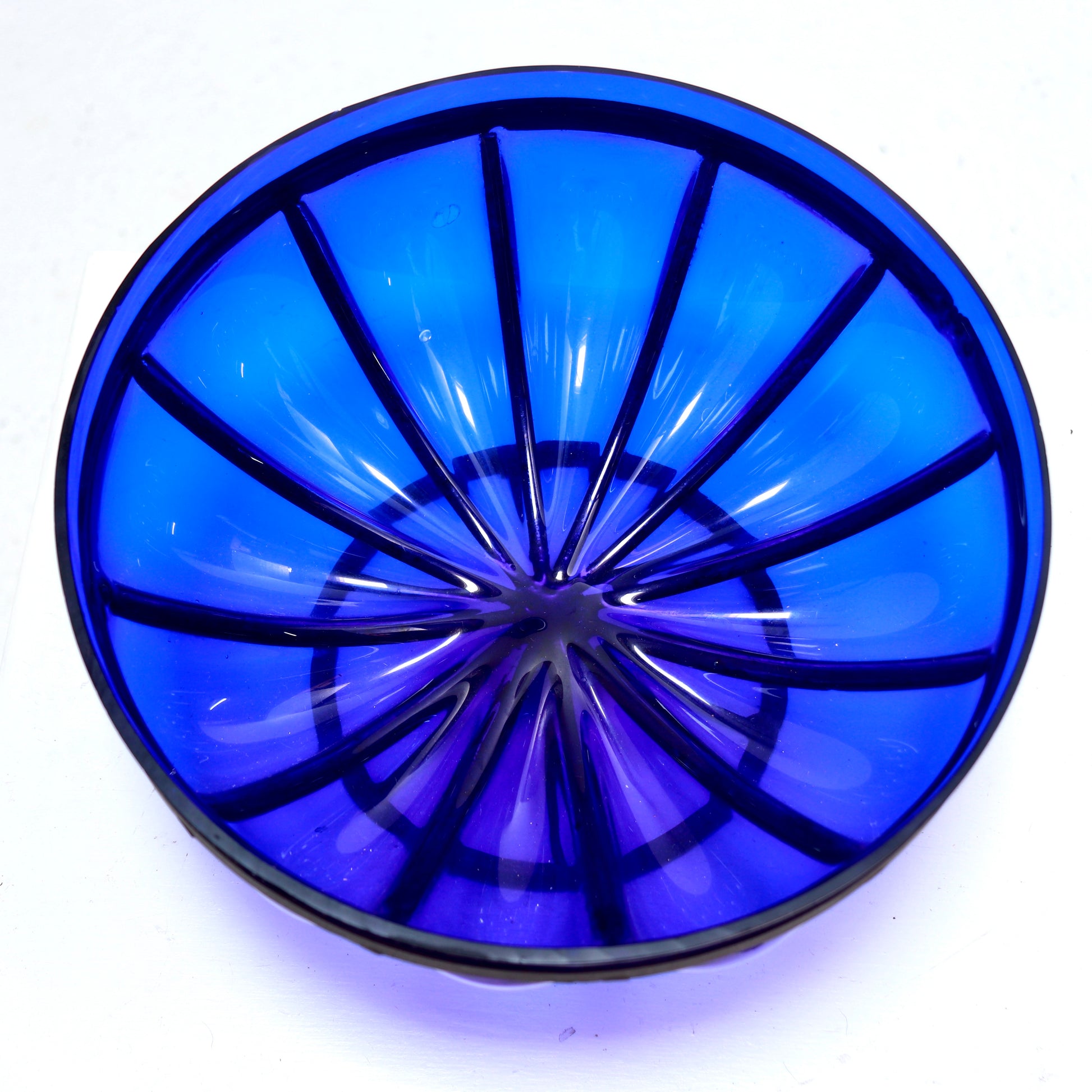 Vintage blue glass bowl detail with metal ribs
