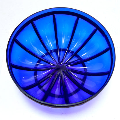 Vintage blue glass bowl detail with metal ribs