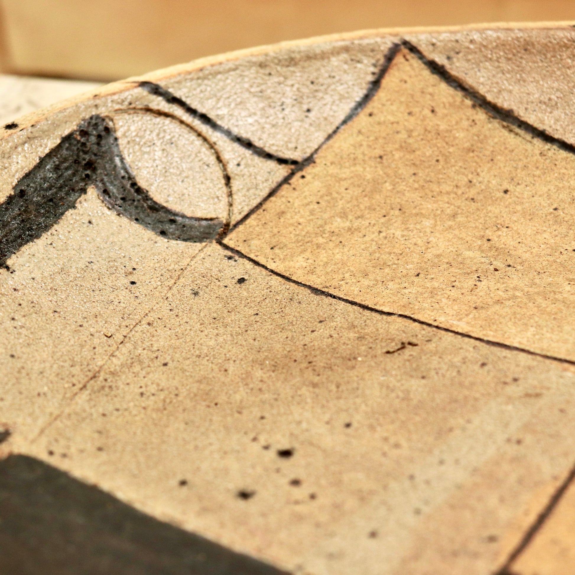 Close-up of abstract painted detail on studio pottery