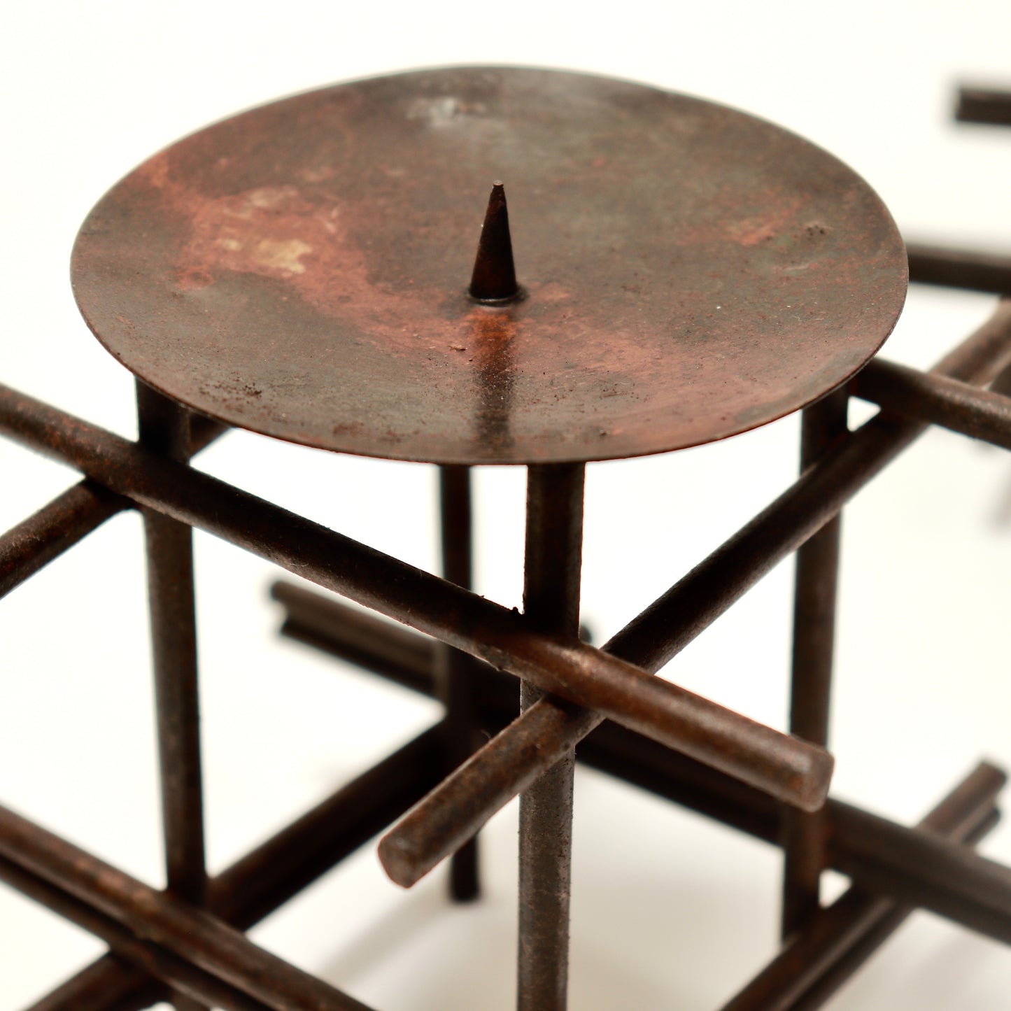 Close-up of steel candle dish and spike