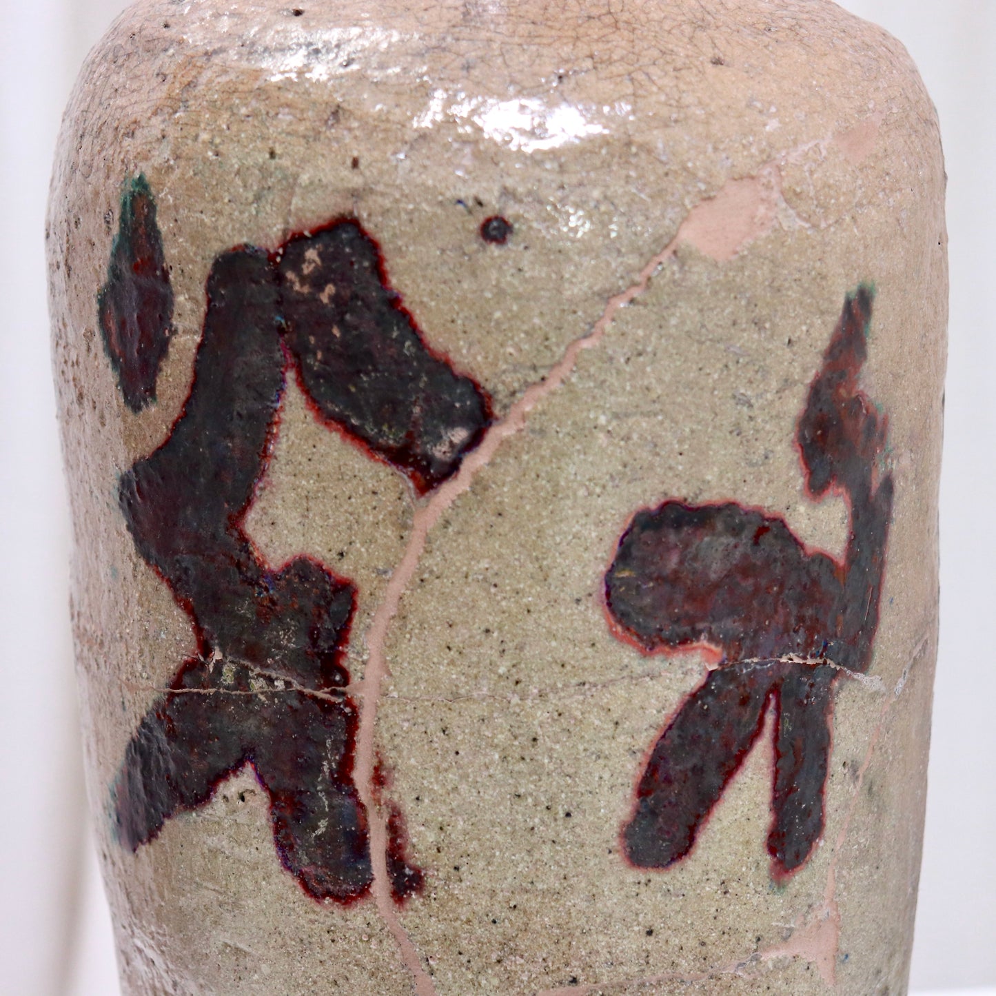 Close-up of calligraphic glaze and crackle surface on vessel