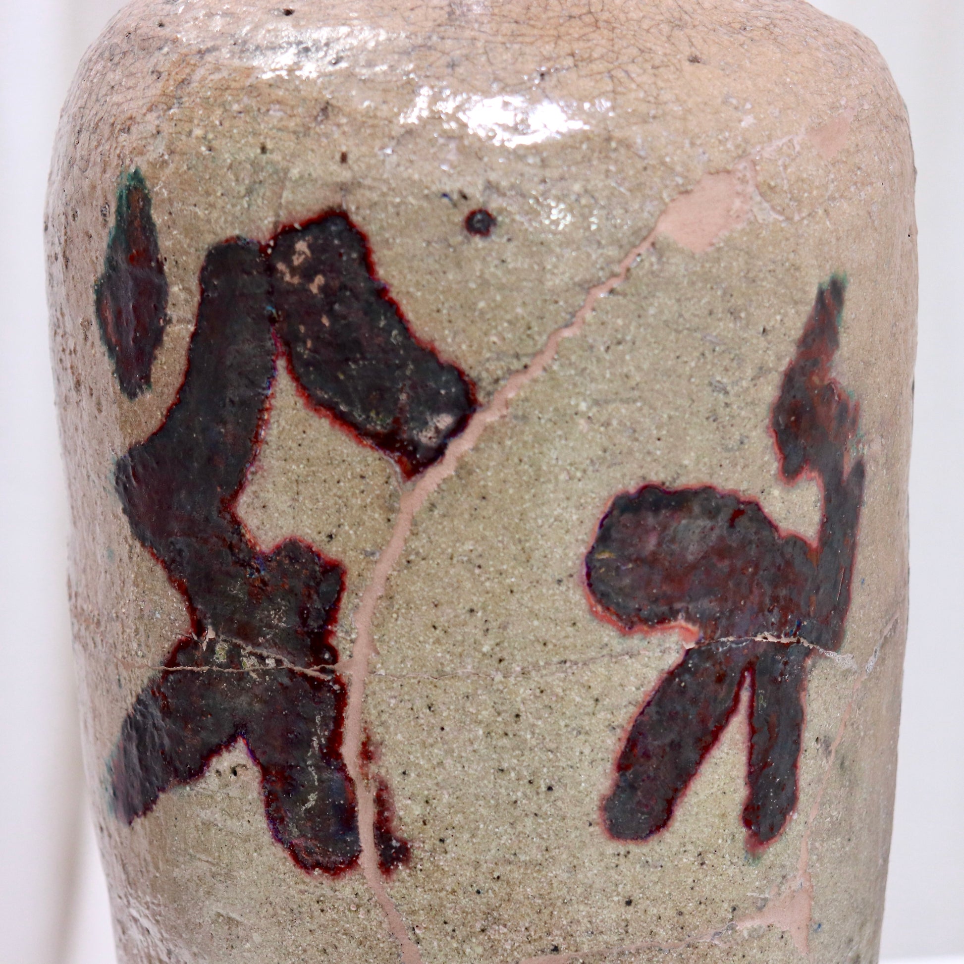 Close-up of calligraphic glaze and crackle surface on vessel