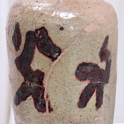 Close-up of calligraphic glaze and crackle surface on vessel