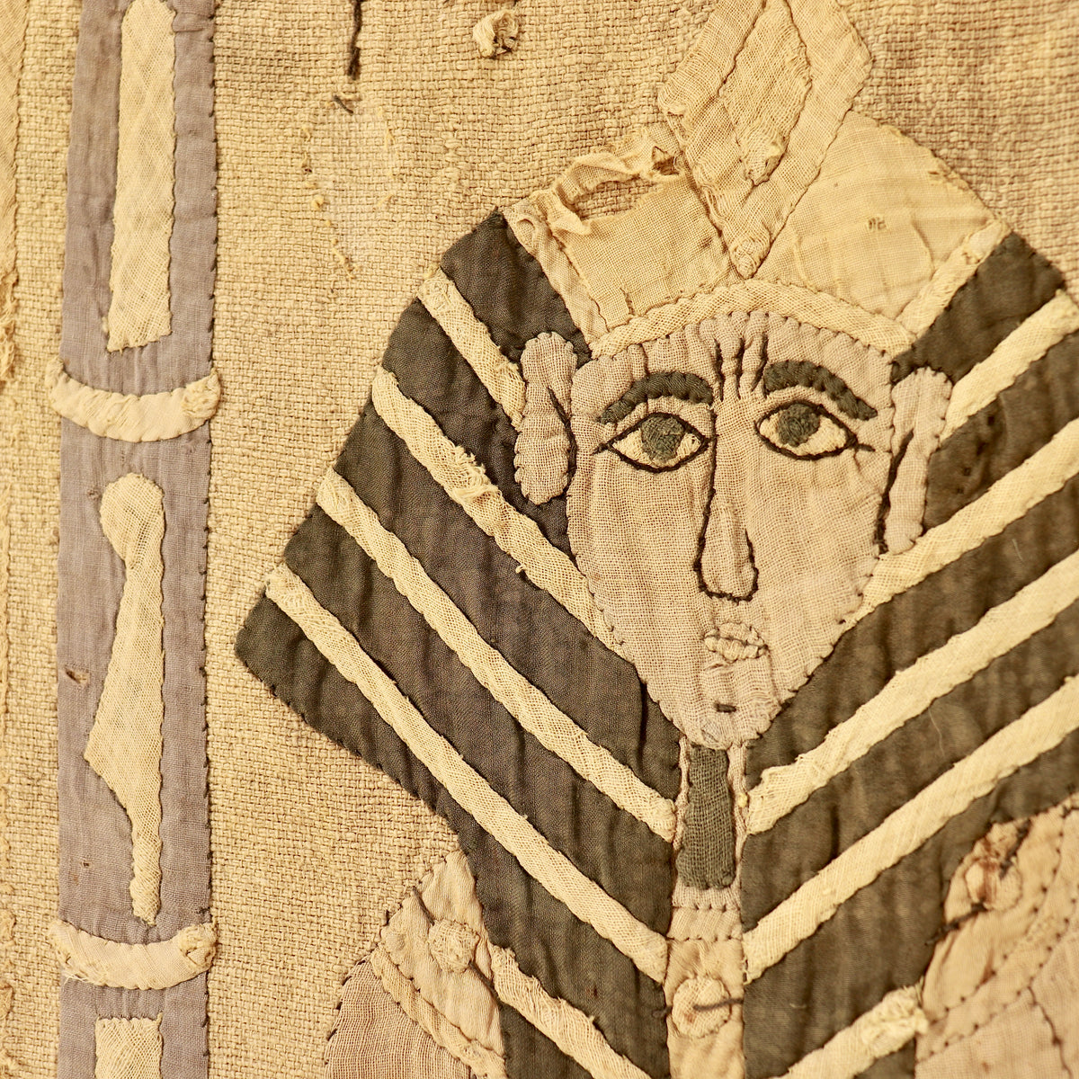 Detail of the appliquéd pharaoh’s face and striped headdress