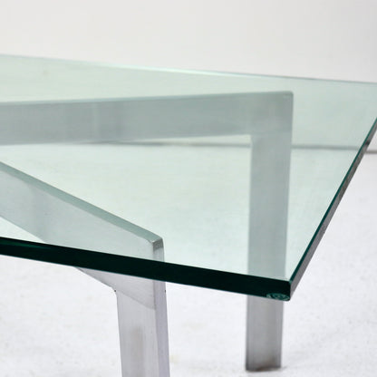 Chamfered glass top on geometric X-frame table