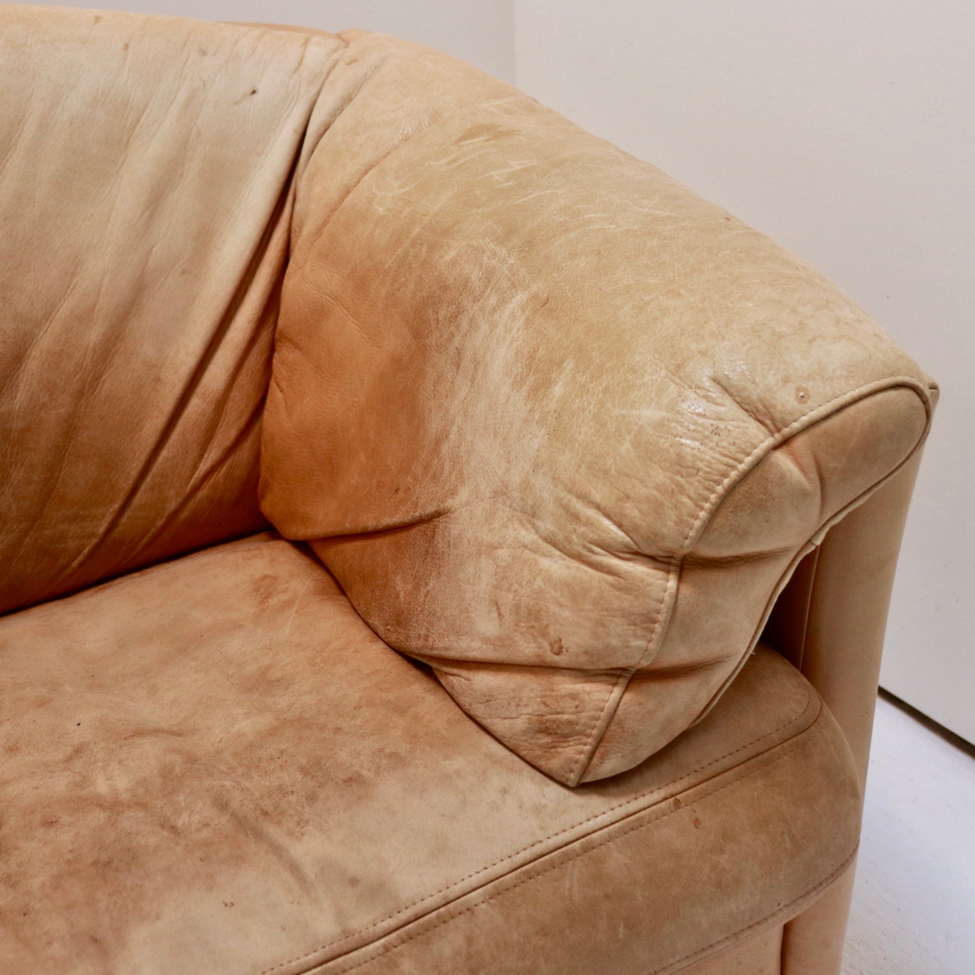 “Detail of wrap-over arm and creased leather patina on Model 535 sofa.”