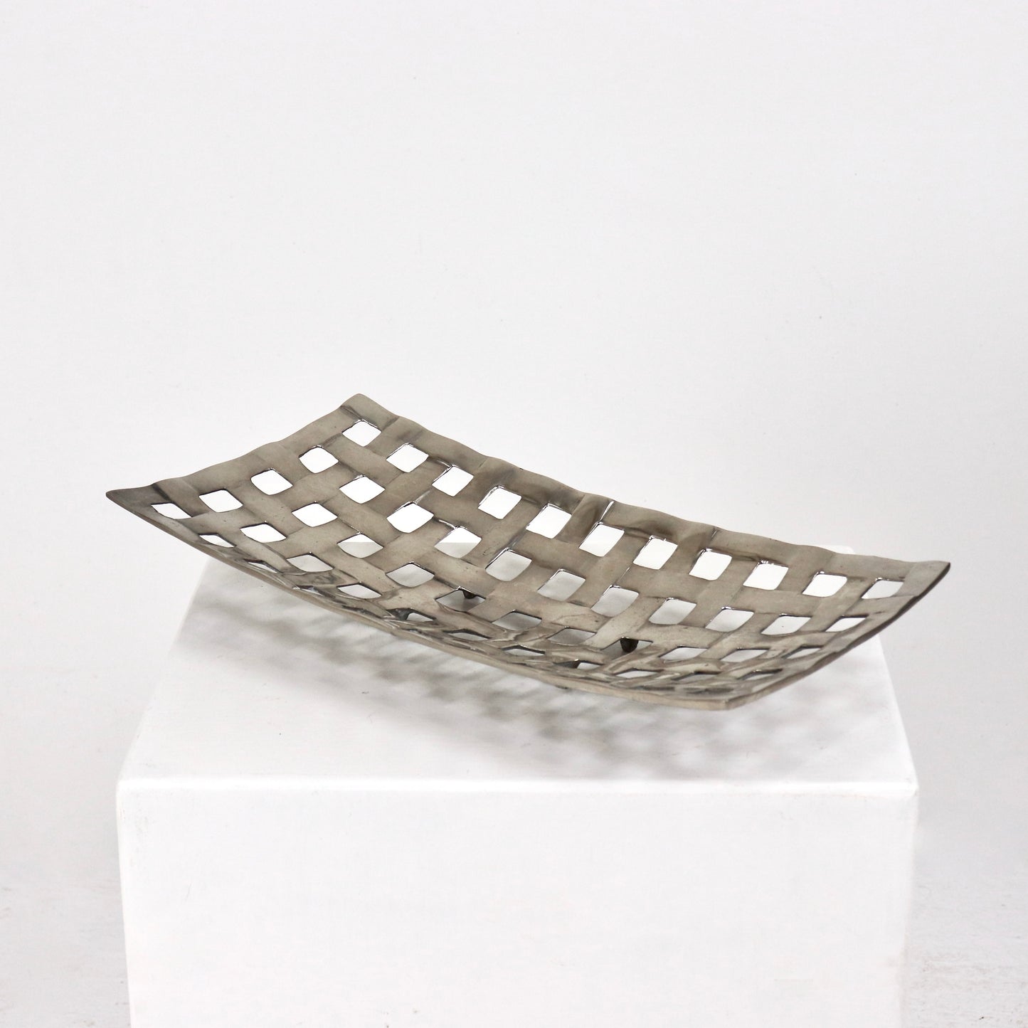 Side profile of cast aluminium woven basket with raised feet
