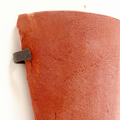 Sculptural terracotta sconces with textured surface