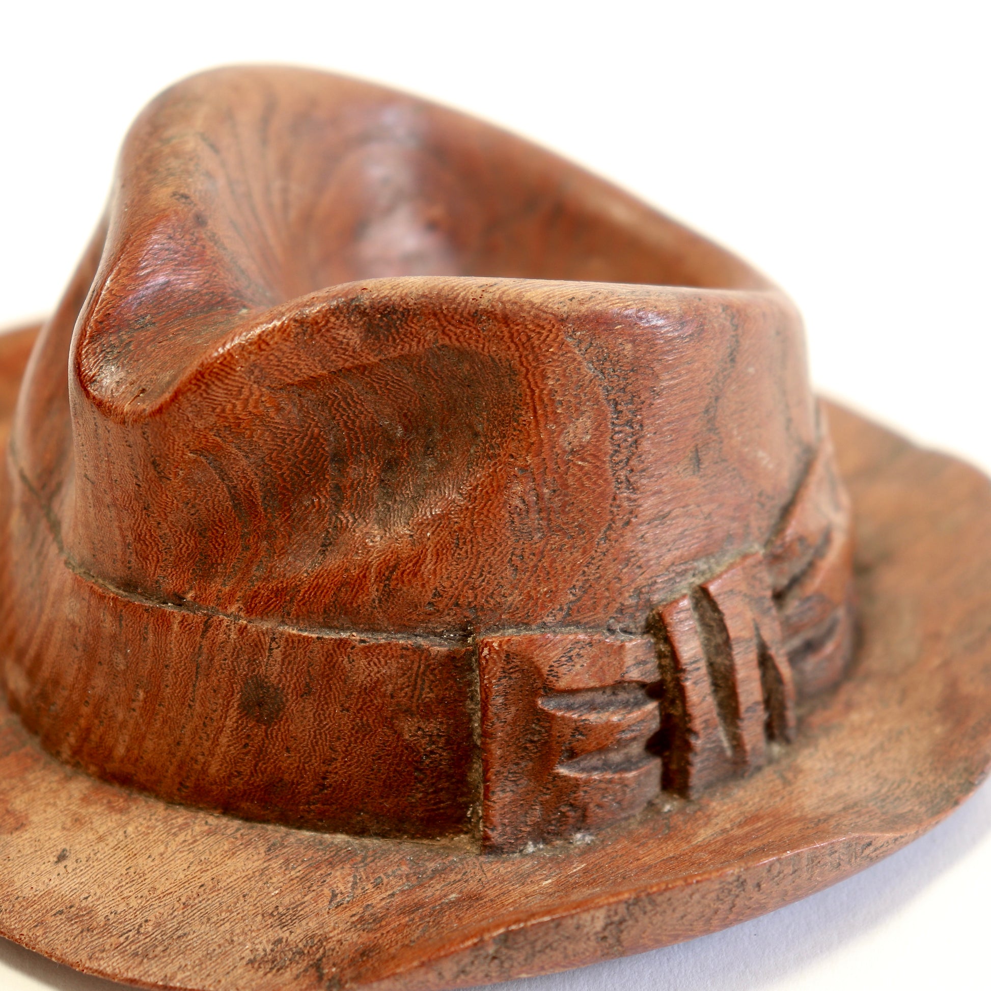 Detail of carved hat band and bow.