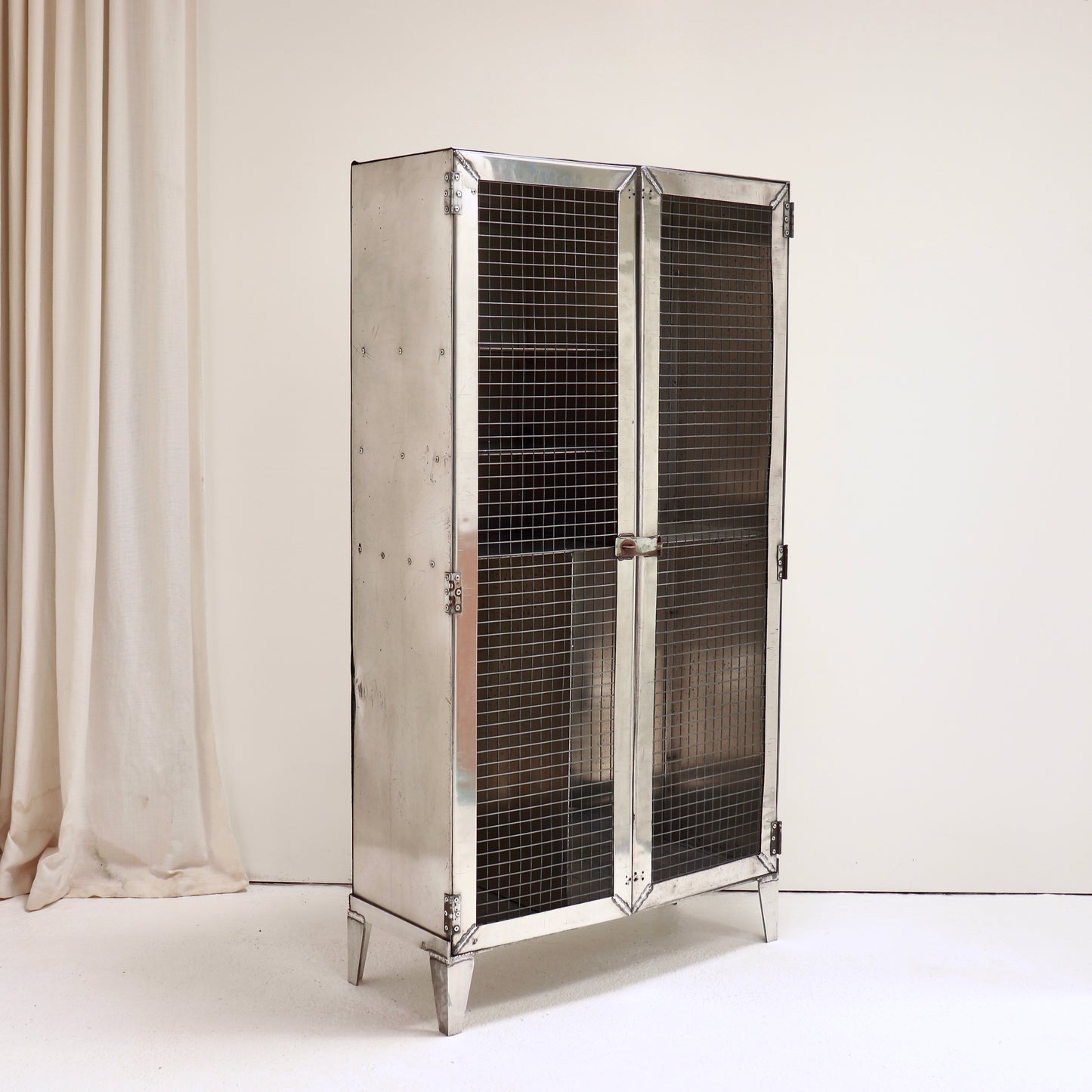 Patinated aluminium industrial cabinet with welded construction.