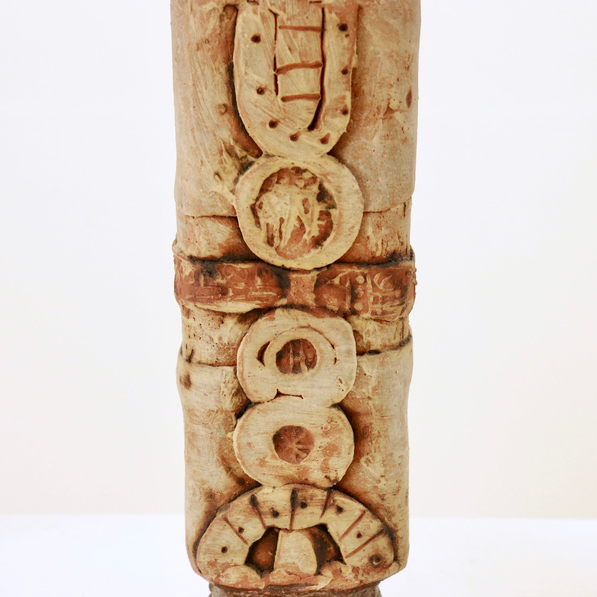 Close-up of carved circular motifs on Bernard Rooke ceramic lamp base