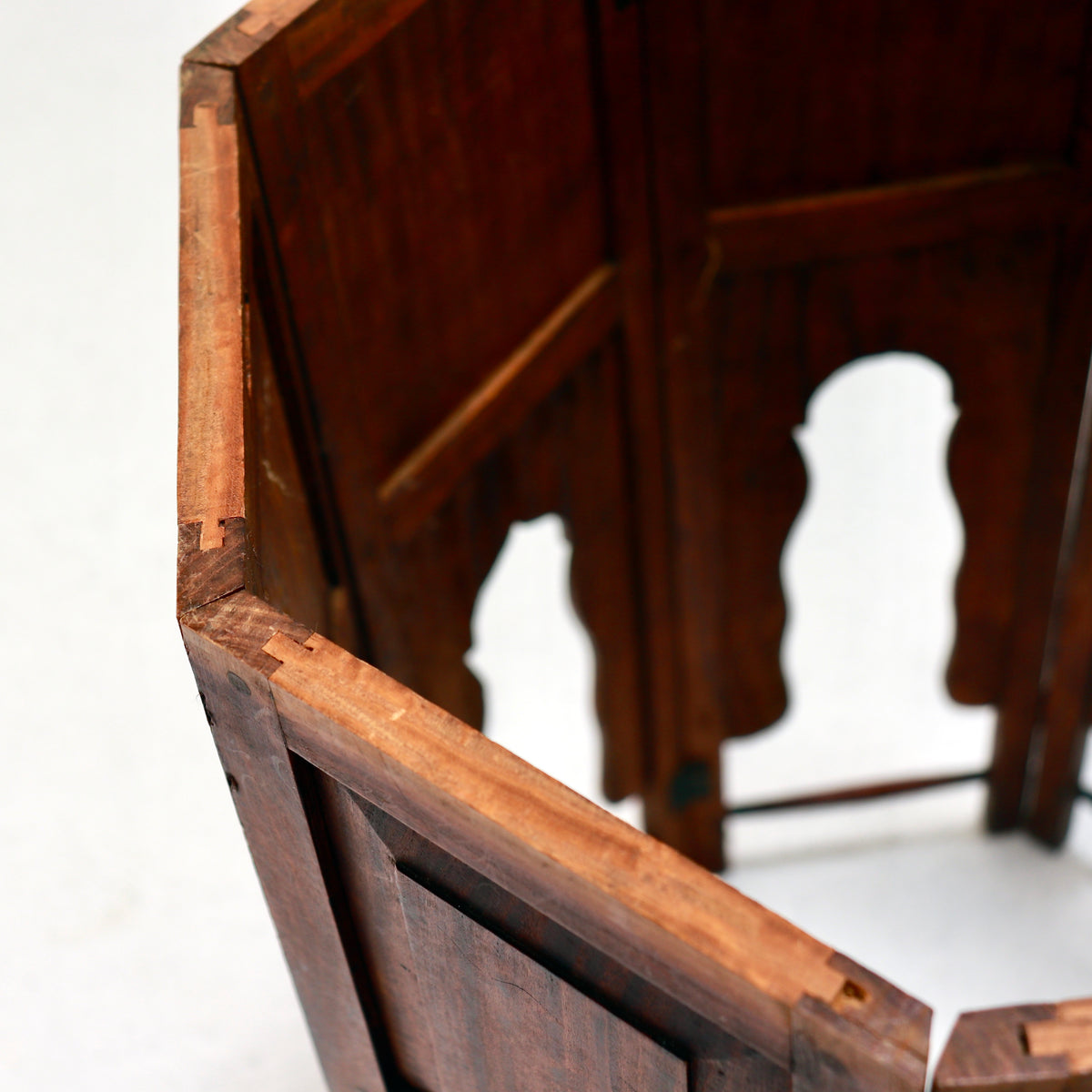 Close-up of a framed wooden base panel showing its grain, fitted joints and age-related wear.