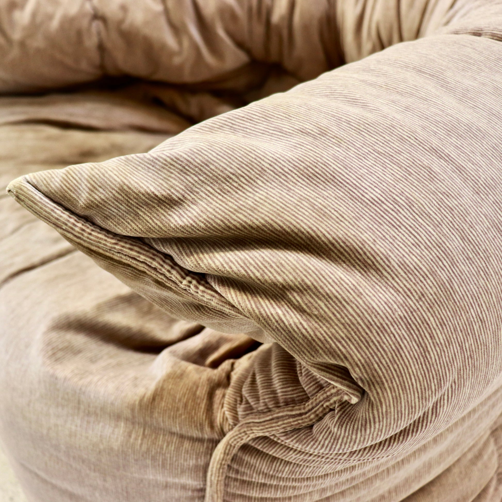 “Detail of quilted, channel-stitched arm and soft pleating on Brigantin chair.”