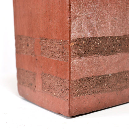 Corner close-up showing grogged clay bands wrapping the base.