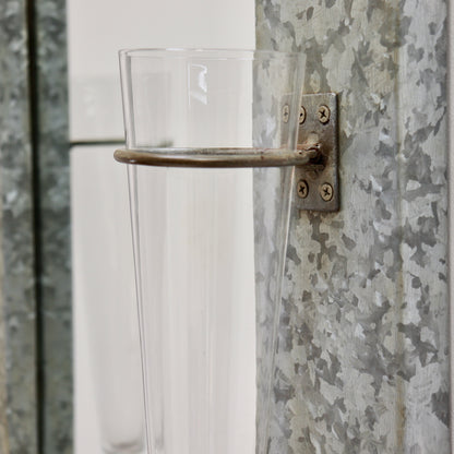 Vintage wall mirror with mounted glass vases detail
