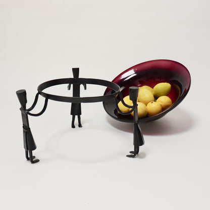 Hand-worked iron stand supporting purple glass bowl