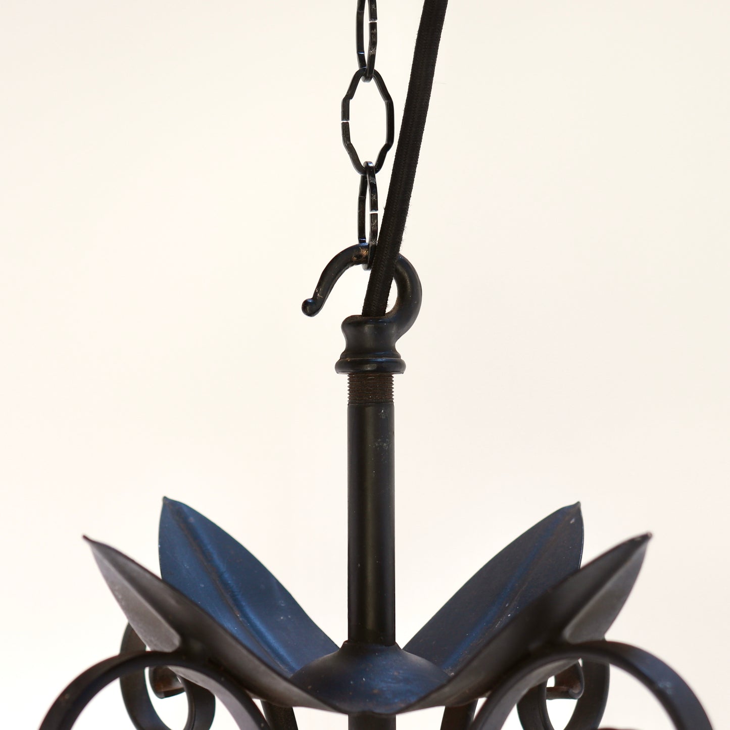 Brutalist hanging light wrought iron scroll detail