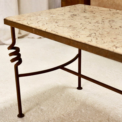 “Vintage coffee table with iron base and spiral detail”