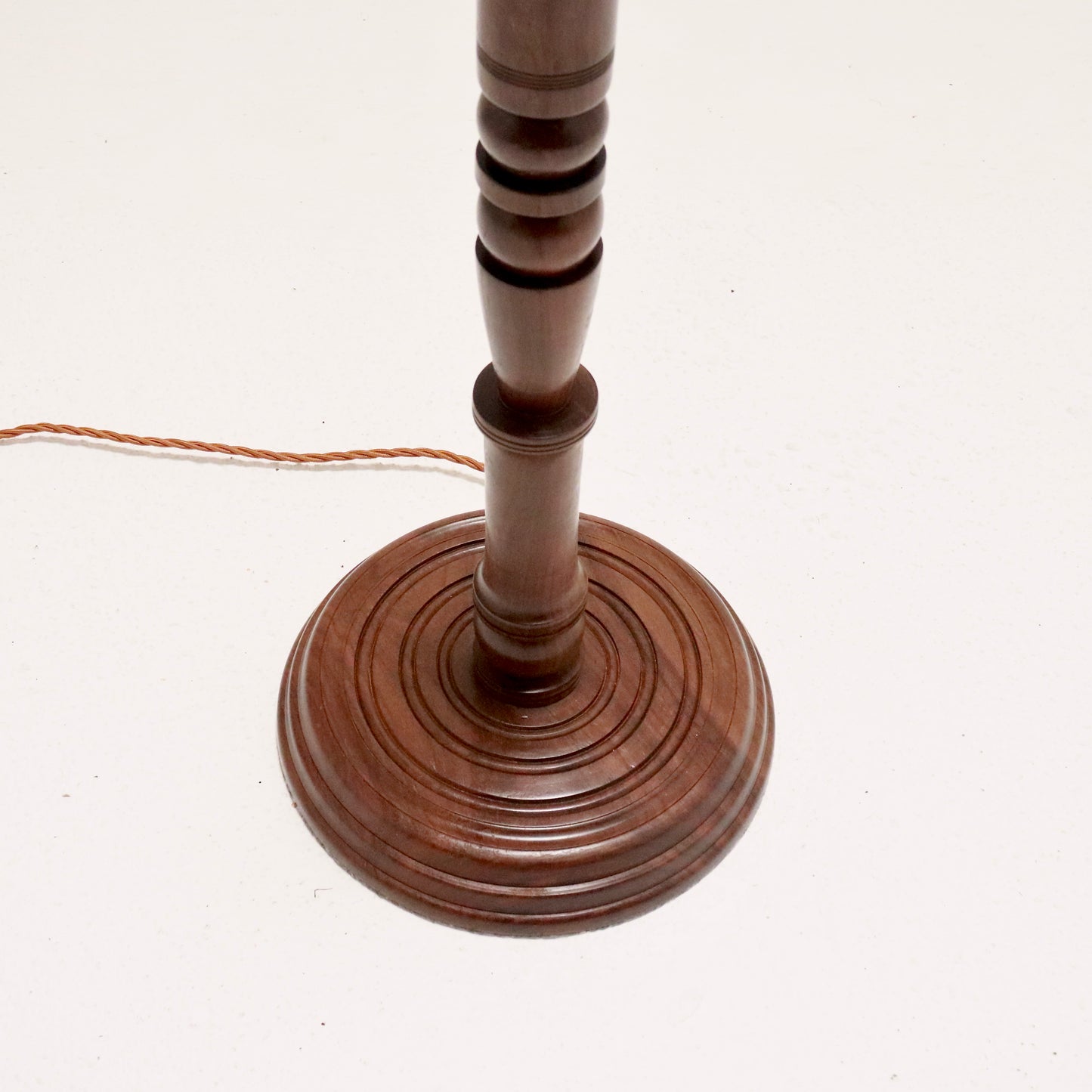 Circular ring-turned walnut base.