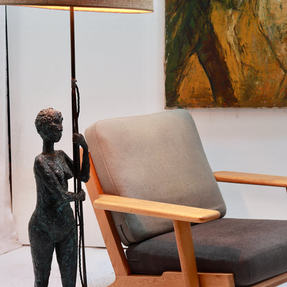 Figural bronzed plaster floor lamp with woven shade