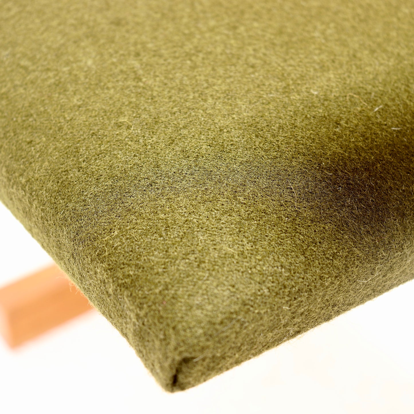 Detail of olive green Kvadrat wool felt seat upholstery
