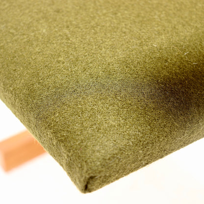Detail of olive green Kvadrat wool felt seat upholstery