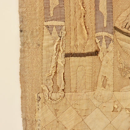 - Detail showing frayed appliqué and losses to the lower design