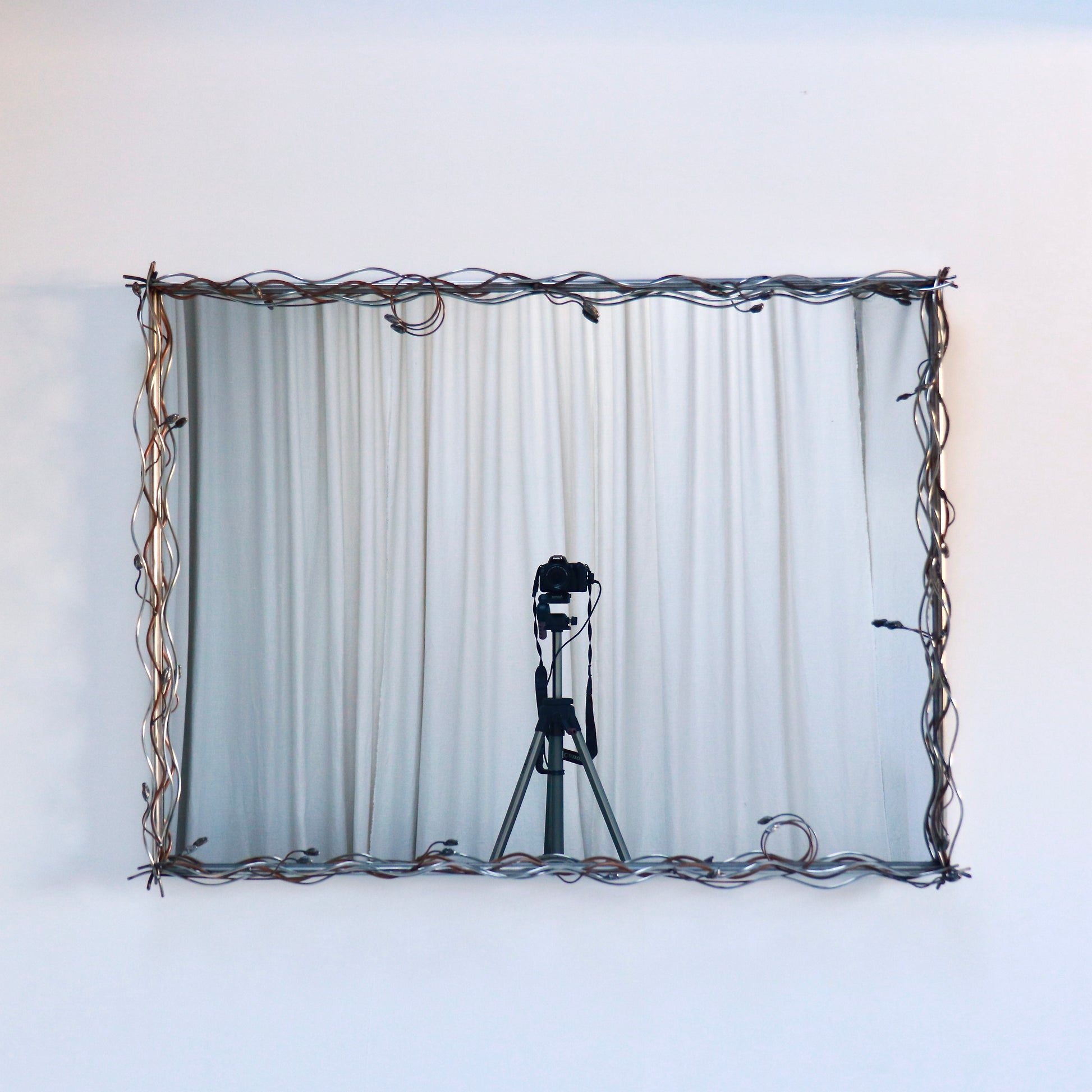 Sculptural metal mirror with organic wire detailing
