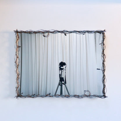 Sculptural metal mirror with organic wire detailing