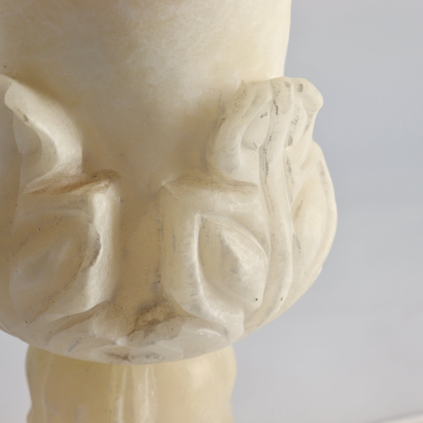 Close-up of carved leaf motif on alabaster lamp